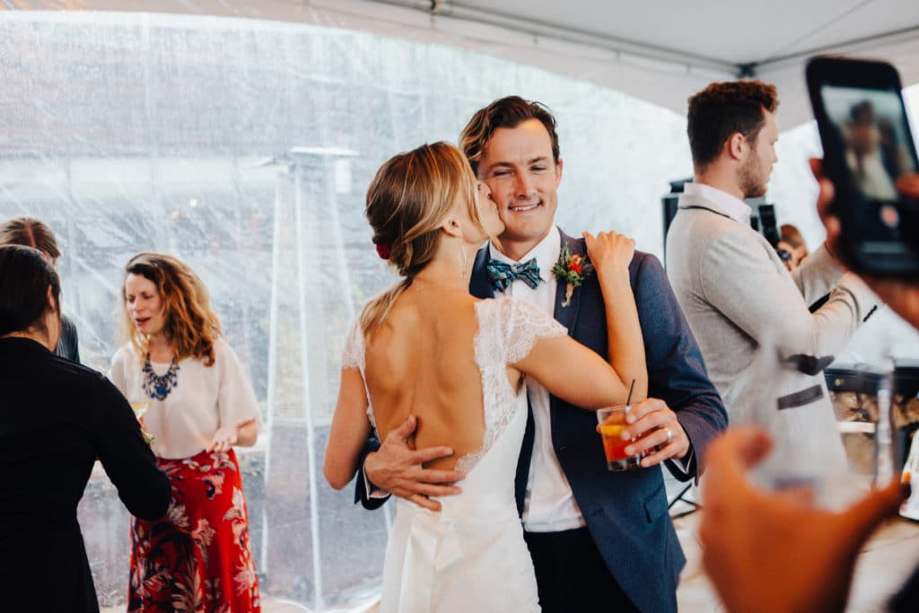 bride and groom under clear tent dancing