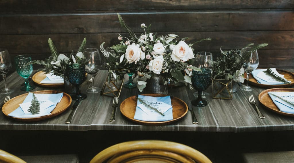 moody tablescape for eco-friendly wedding with ferns and wooden plates