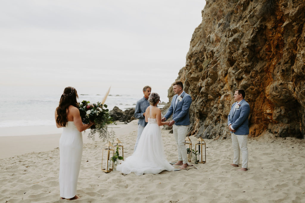 Small beach elopement in Laguna Beach California with lanterns and boho rug