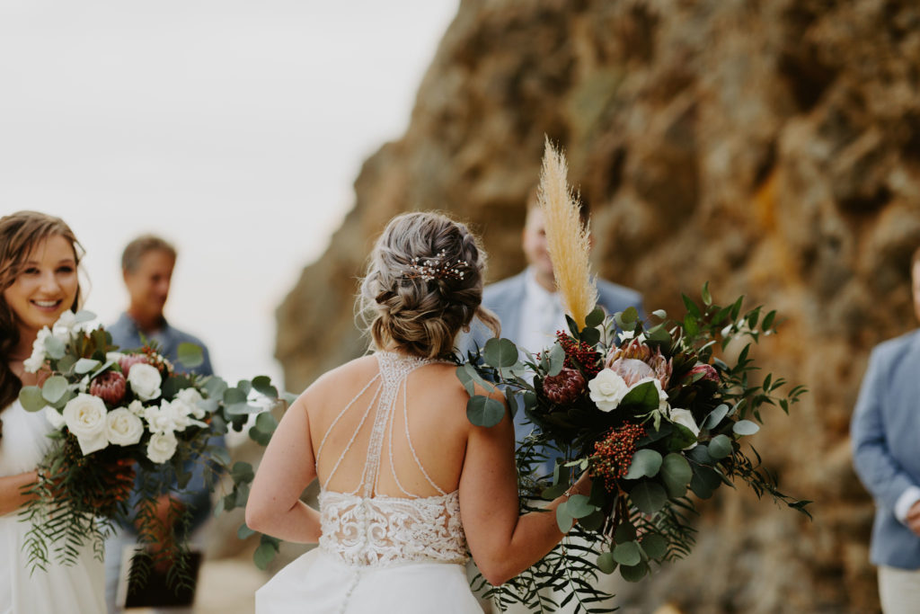 Bride walks down the beach and sees her groom for the first time in Laguna Beach