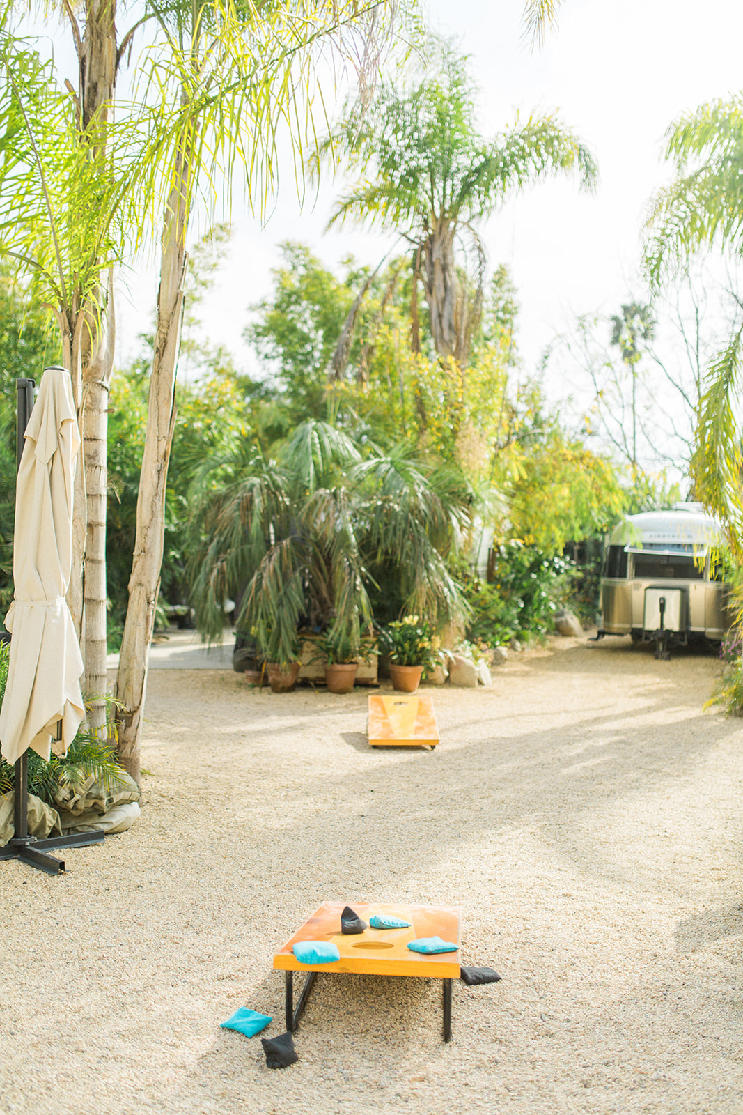 Wedding guests can play corn hole outside during cocktail hour at Caravan Outpost in Ojai