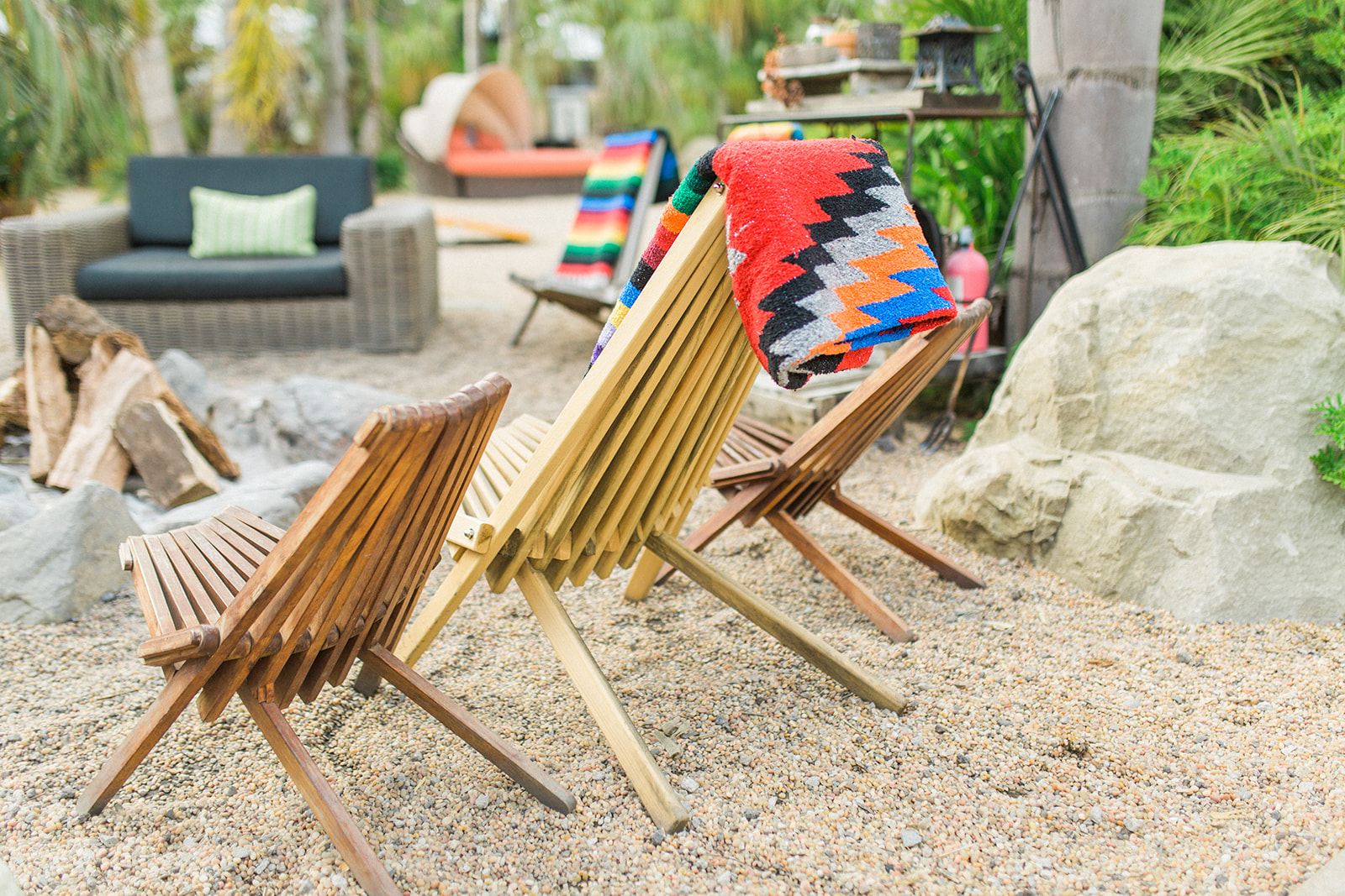 Firepit where guests can lounge during the wedding with colorful Mexican blankets