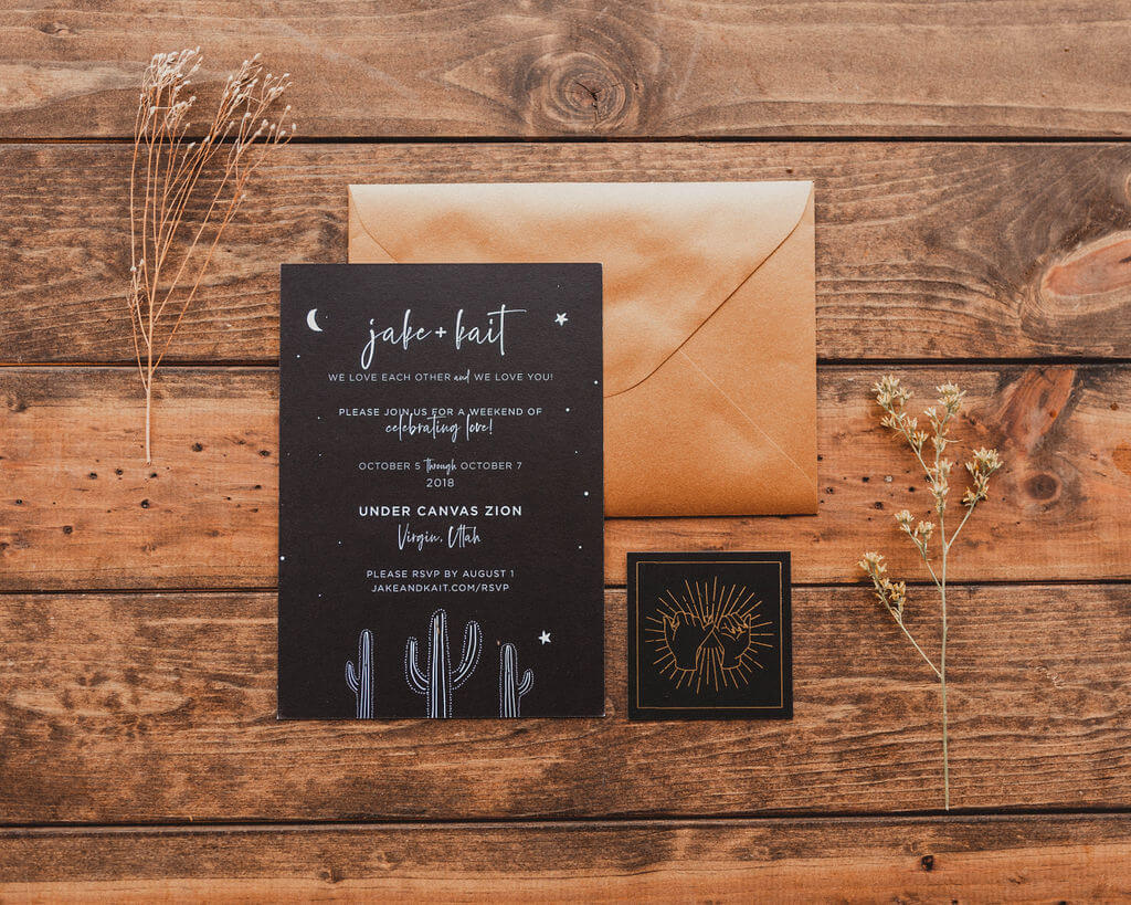 Black and gold wedding invitations with stars, moons and cacti