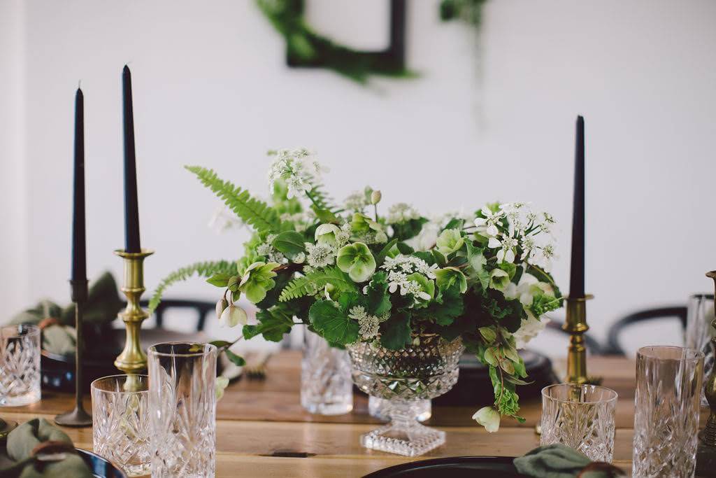 Simple white and green flowers with black candlesticks for eco friendly wedding